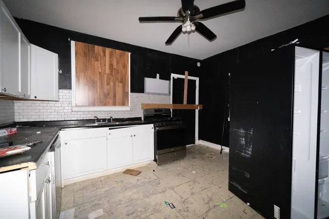 a kitchen with a refrigerator and a sink