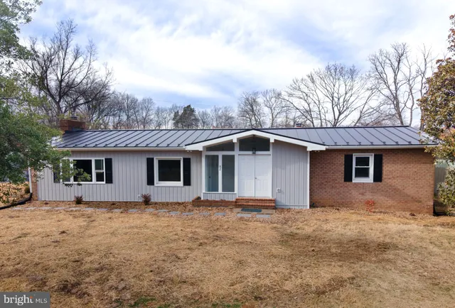 a front view of house with yard and trees