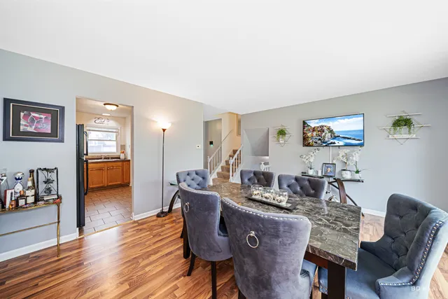 a dining room with furniture and wooden floor