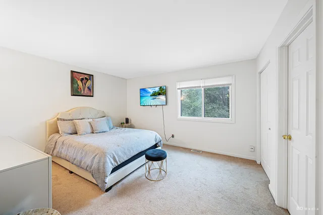 a bedroom with a bed and window