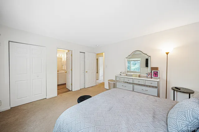 a bedroom with a bed and a mirror on dresser