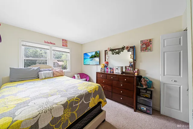 a bedroom with a bed and a dresser