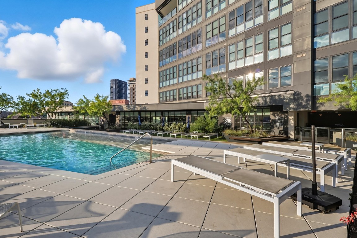 800 Embassy Drive, Unit 320 Austin, TX 78702 - Photo 17 of 23 a swimming pool with outdoor seating and yard