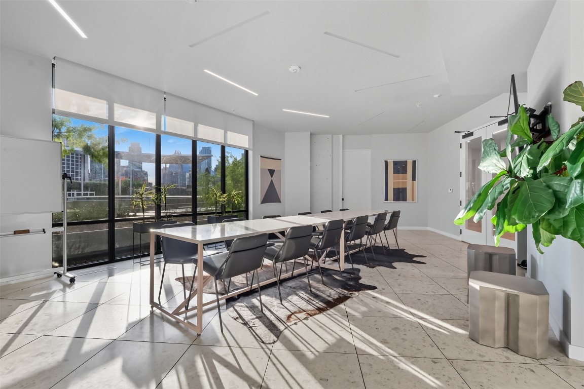 800 Embassy Drive, Unit 320 Austin, TX 78702 - Photo 22 of 23 a living room with furniture potted plant and a large window