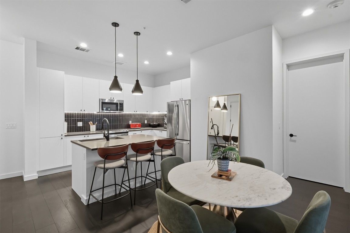 800 Embassy Drive, Unit 320 Austin, TX 78702 - Photo 3 of 23 a table and chairs in a kitchen