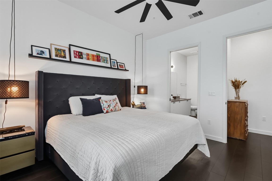 800 Embassy Drive, Unit 320 Austin, TX 78702 - Photo 7 of 23 a bedroom with a bed and a lamp