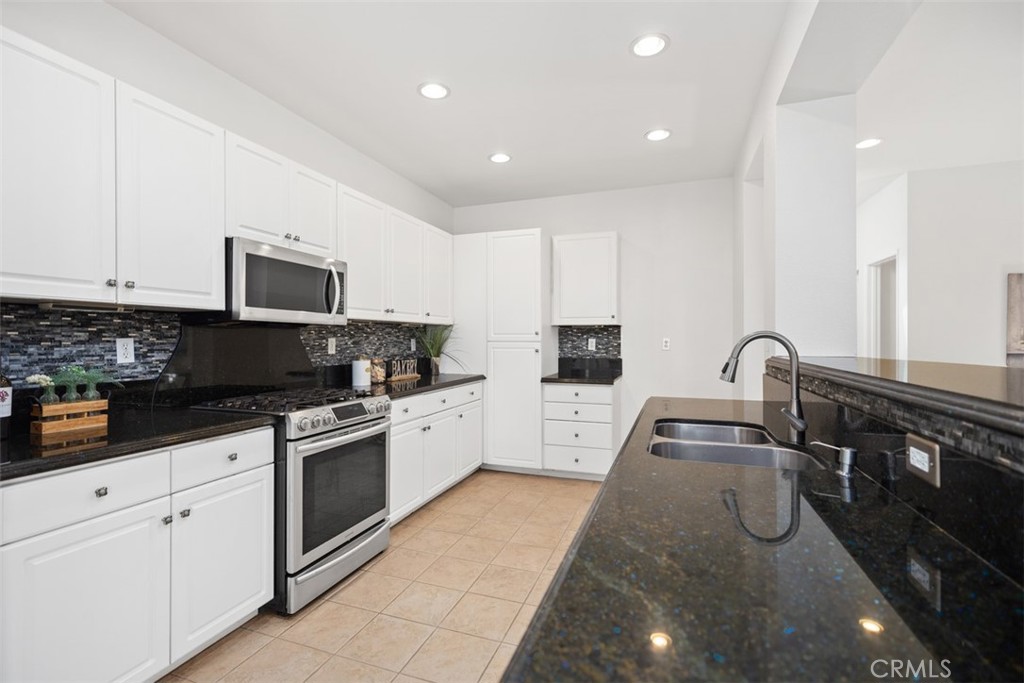 39 Ohio Irvine, CA 92606 - Photo 13 of 46 a kitchen with granite countertop a sink stainless steel appliances and cabinets