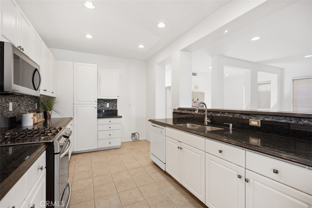 39 Ohio Irvine, CA 92606 - Photo 14 of 46 a large kitchen with stainless steel appliances a sink a stove and cabinets