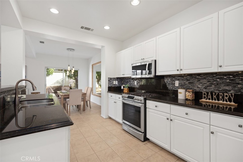 39 Ohio Irvine, CA 92606 - Photo 15 of 46 a kitchen with white cabinets a sink and appliances