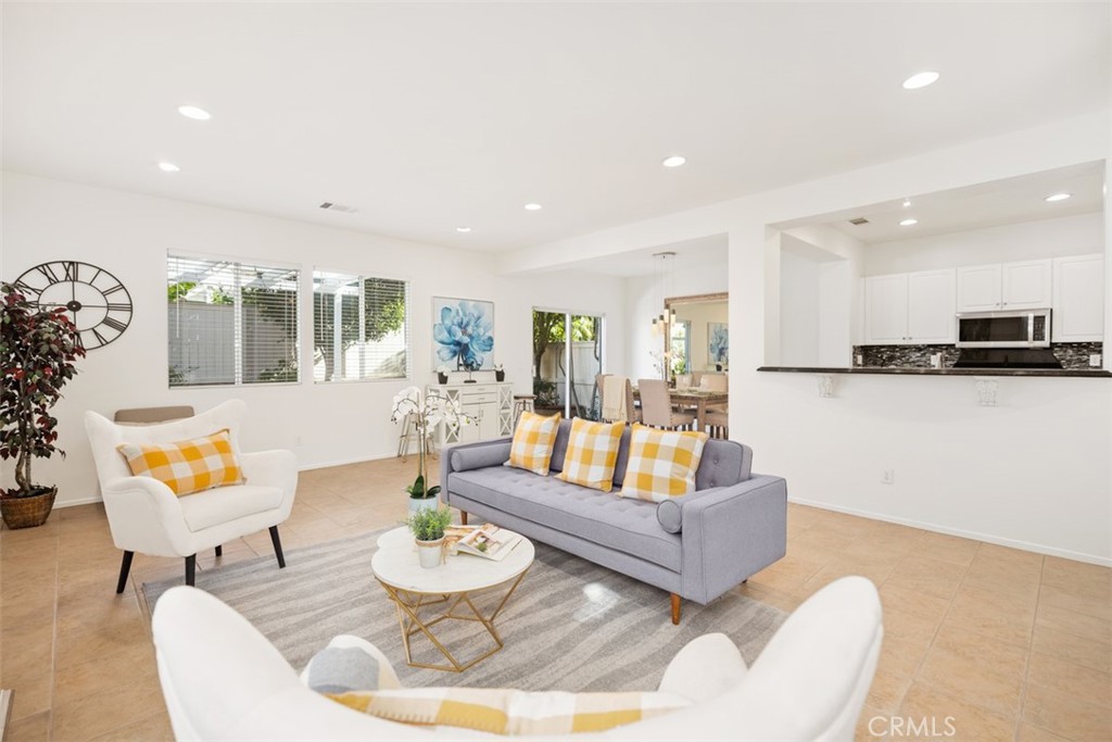 39 Ohio Irvine, CA 92606 - Photo 8 of 46 a living room with furniture and a dining table with kitchen view