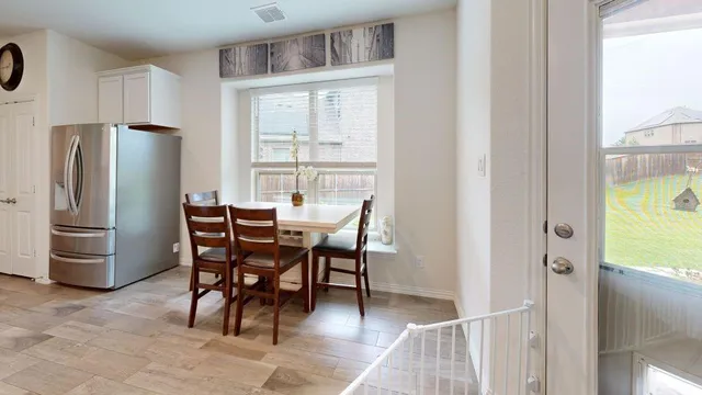 a view of a dining room with furniture and a window