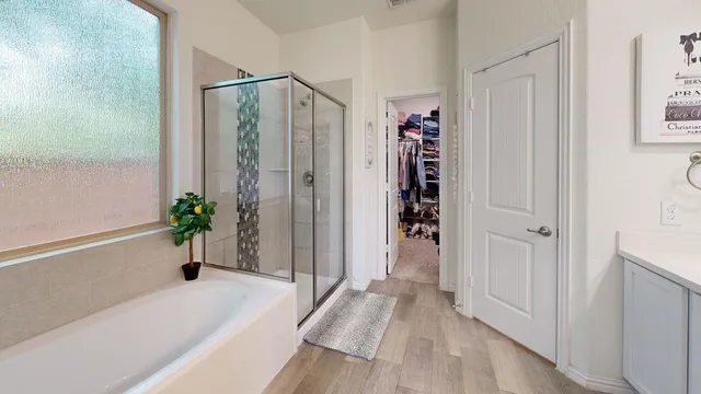 a view of a bathroom with a tub and shower