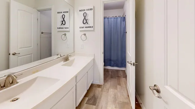 a living room with furniture a flat screen tv and a refrigerator
