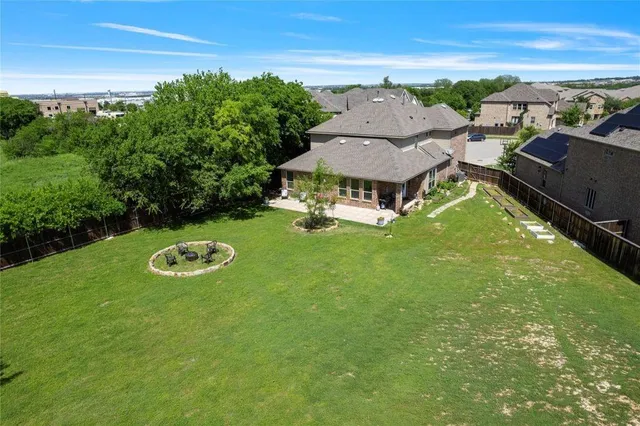 an aerial view of a house with garden space and ocean view