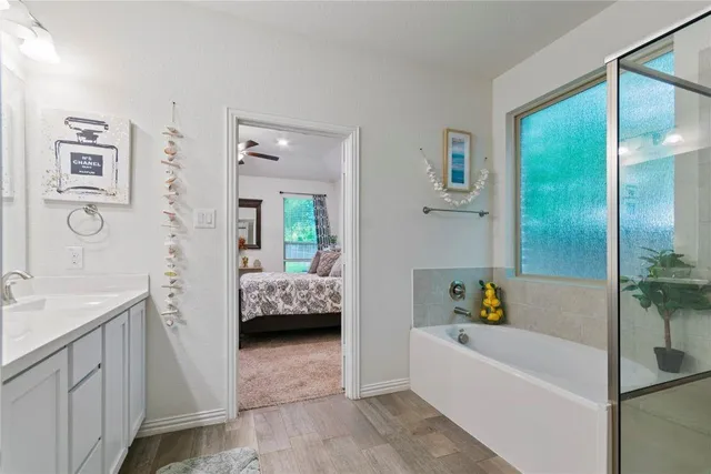 a bathroom with a double vanity sink and a mirror