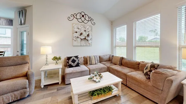 a living room with furniture and a large window