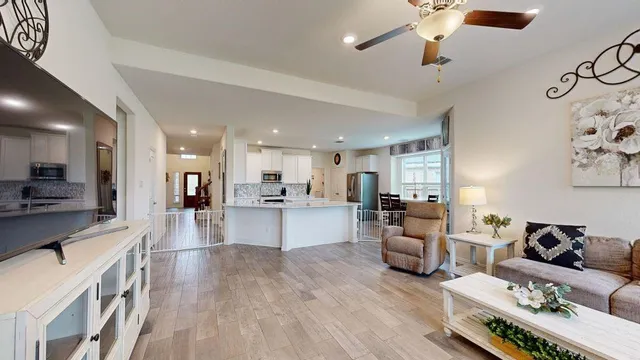a living room with furniture and kitchen view