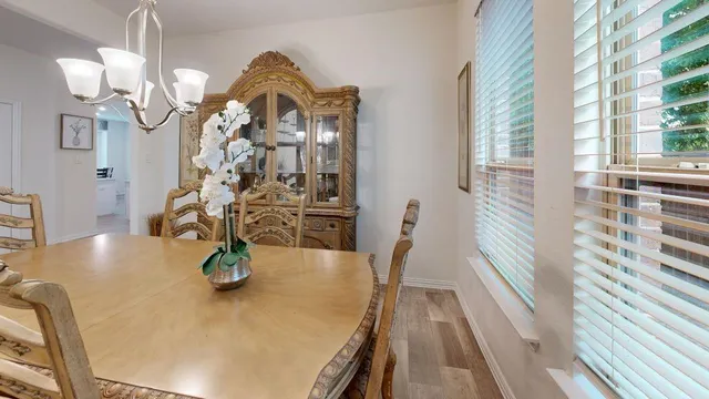 a view of a dining room with furniture and wooden floor