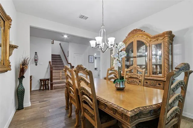 a dining room with furniture entryway and wooden floor