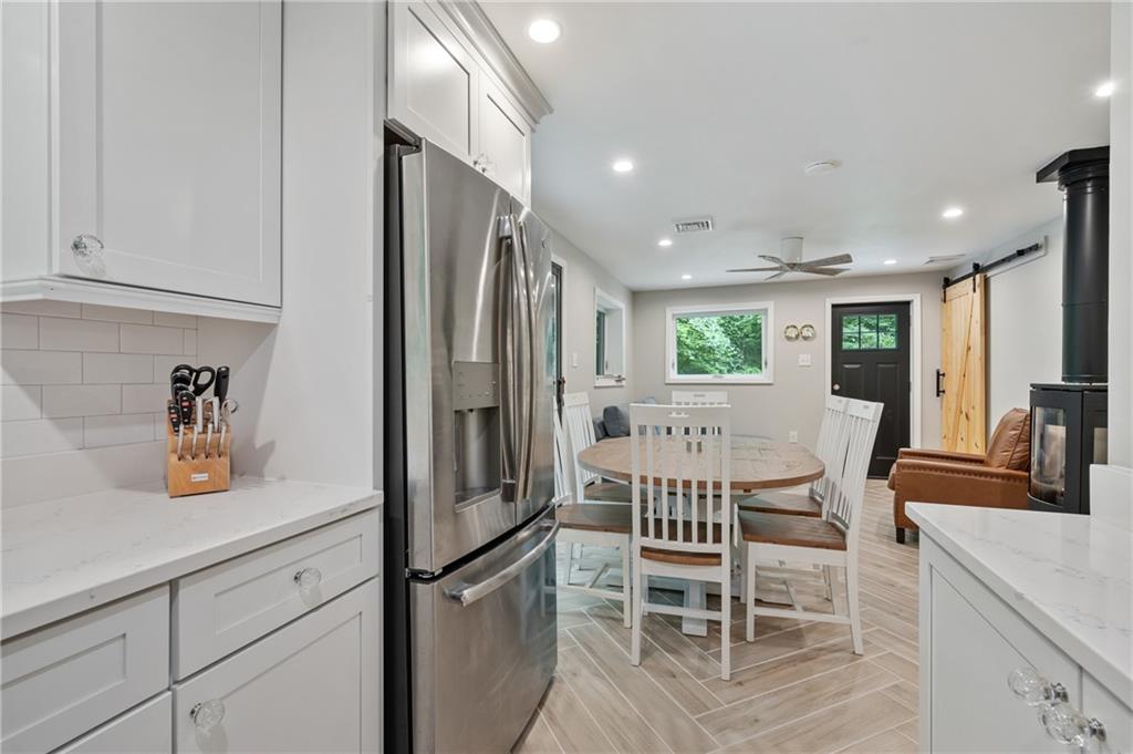 290 Pirich Road Addison, PA 15411 - Photo 13 of 37 a kitchen with stainless steel appliances granite countertop a dining table chairs refrigerator and sink