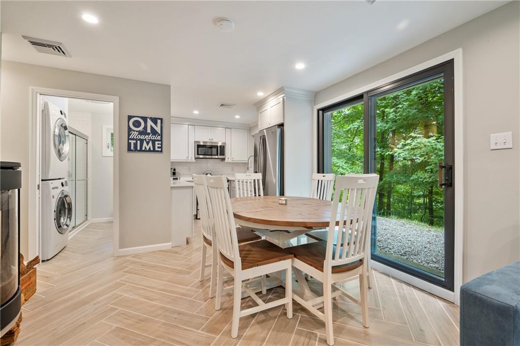 290 Pirich Road Addison, PA 15411 - Photo 5 of 37 a view of a dining room with furniture a rug and wooden floor