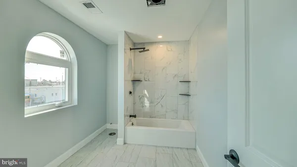 a bathroom with a bathtub and a shower