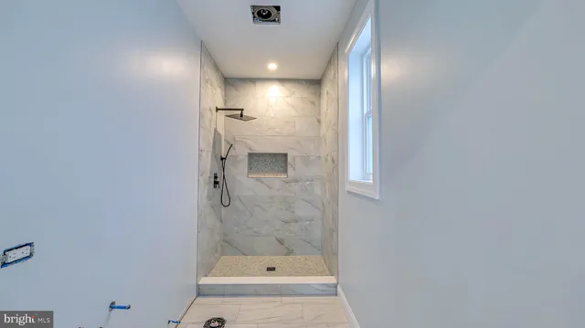 a bathroom with a bathtub and shower