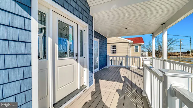 a view of balcony with a large window and wooden floor