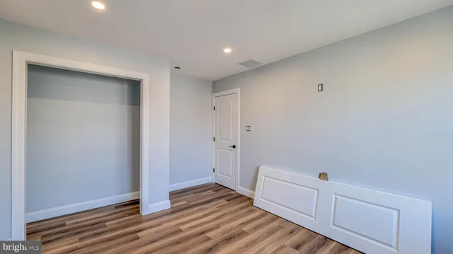a view of a room with wooden floor