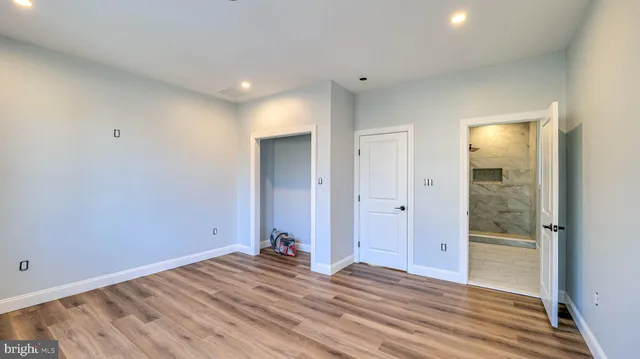 a view of a room with wooden floor and bathroom