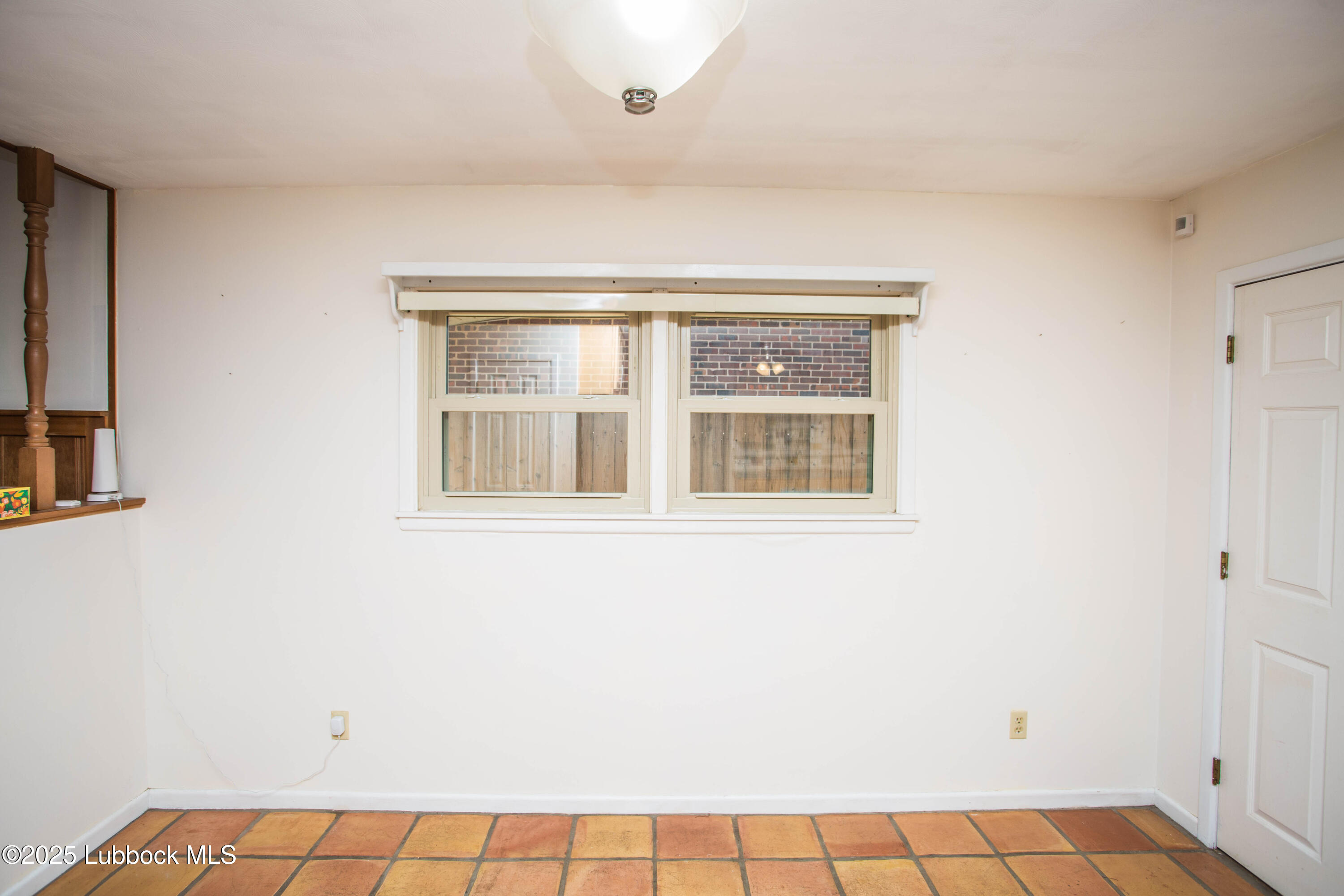 5424 31st Street Lubbock, TX 79407 - Photo 16 of 45 a view of an empty room with a window