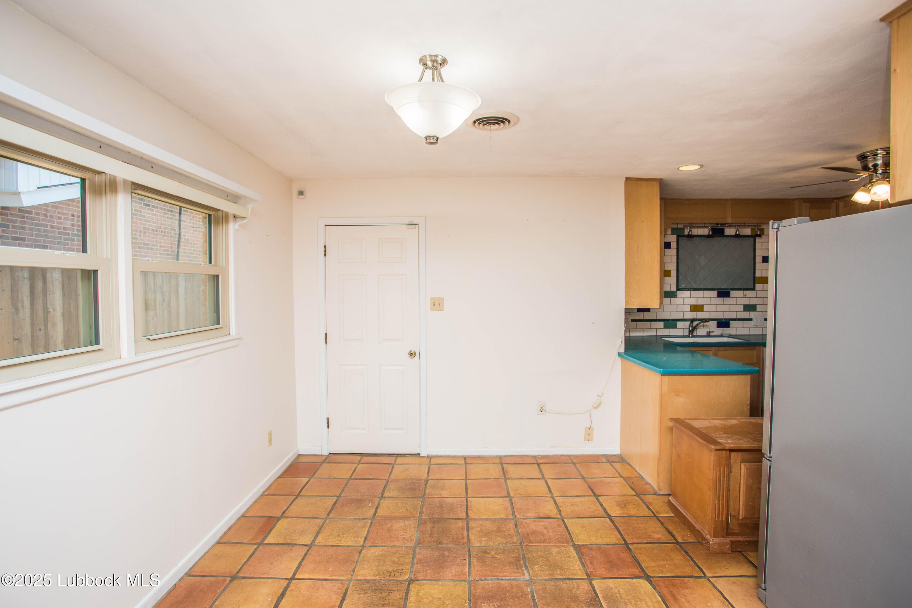 5424 31st Street Lubbock, TX 79407 - Photo 17 of 45 a kitchen with a refrigerator and a stove