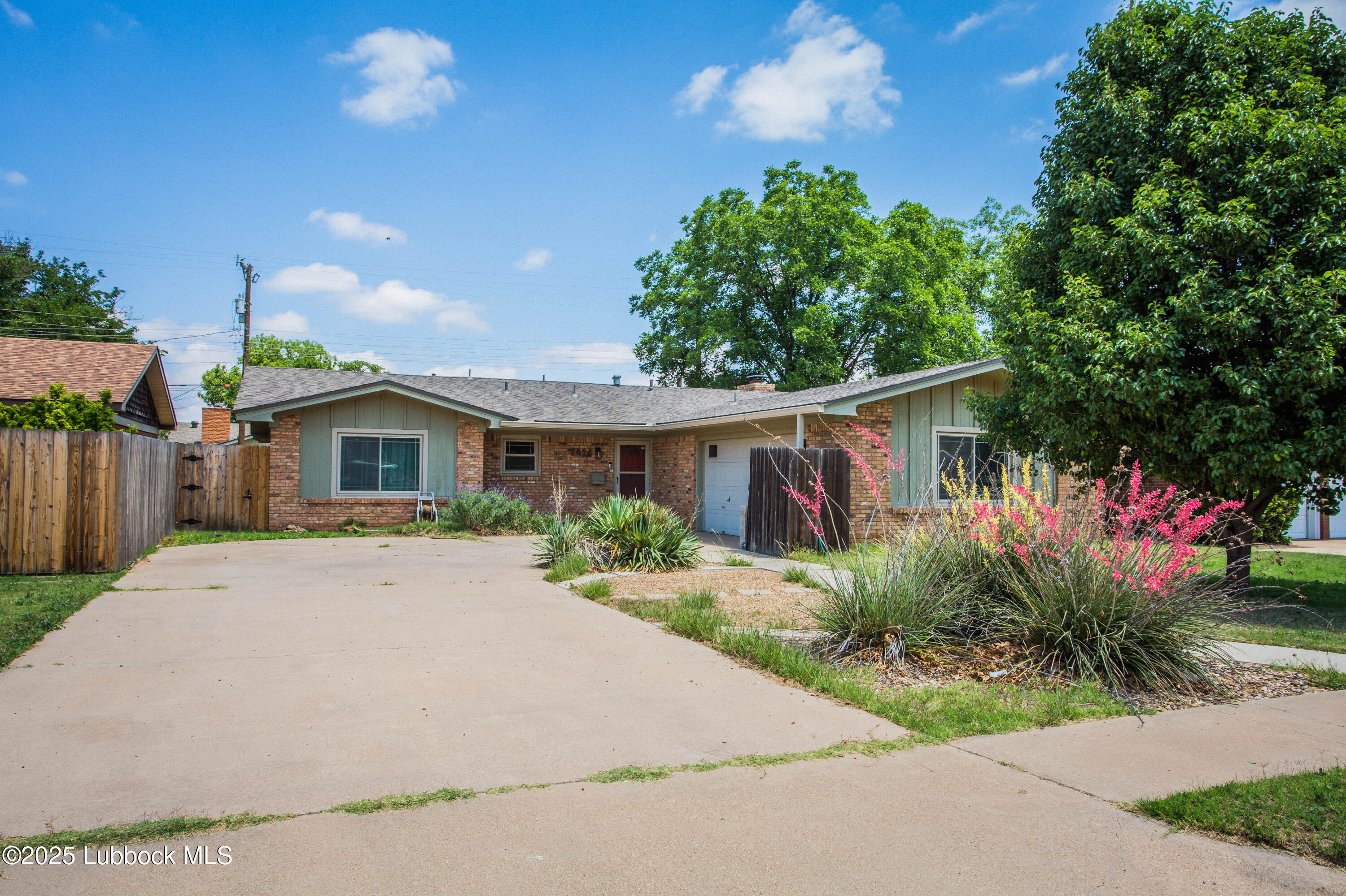 5424 31st Street Lubbock, TX 79407 - Photo 2 of 45 a front view of house with yard and trees around
