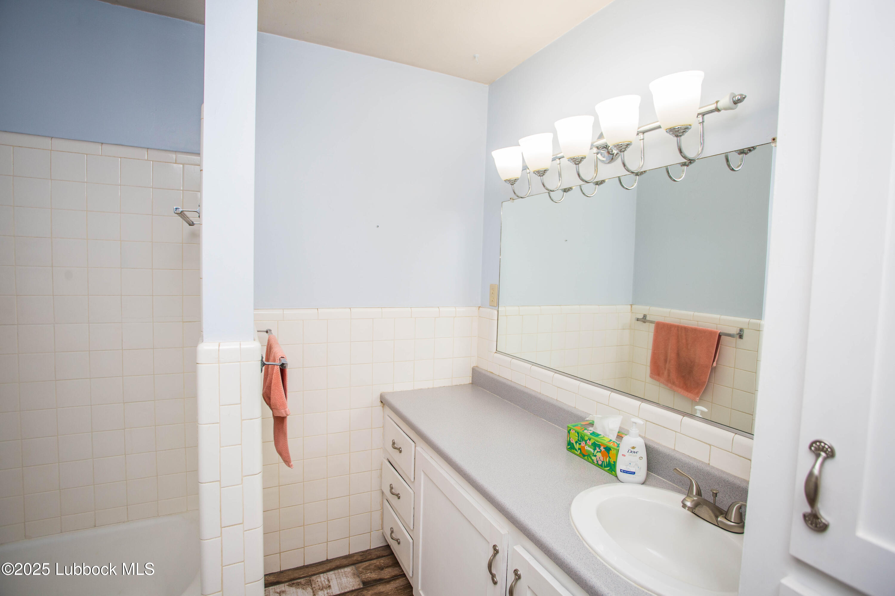 5424 31st Street Lubbock, TX 79407 - Photo 23 of 45 a bathroom with a sink a vanity and a mirror