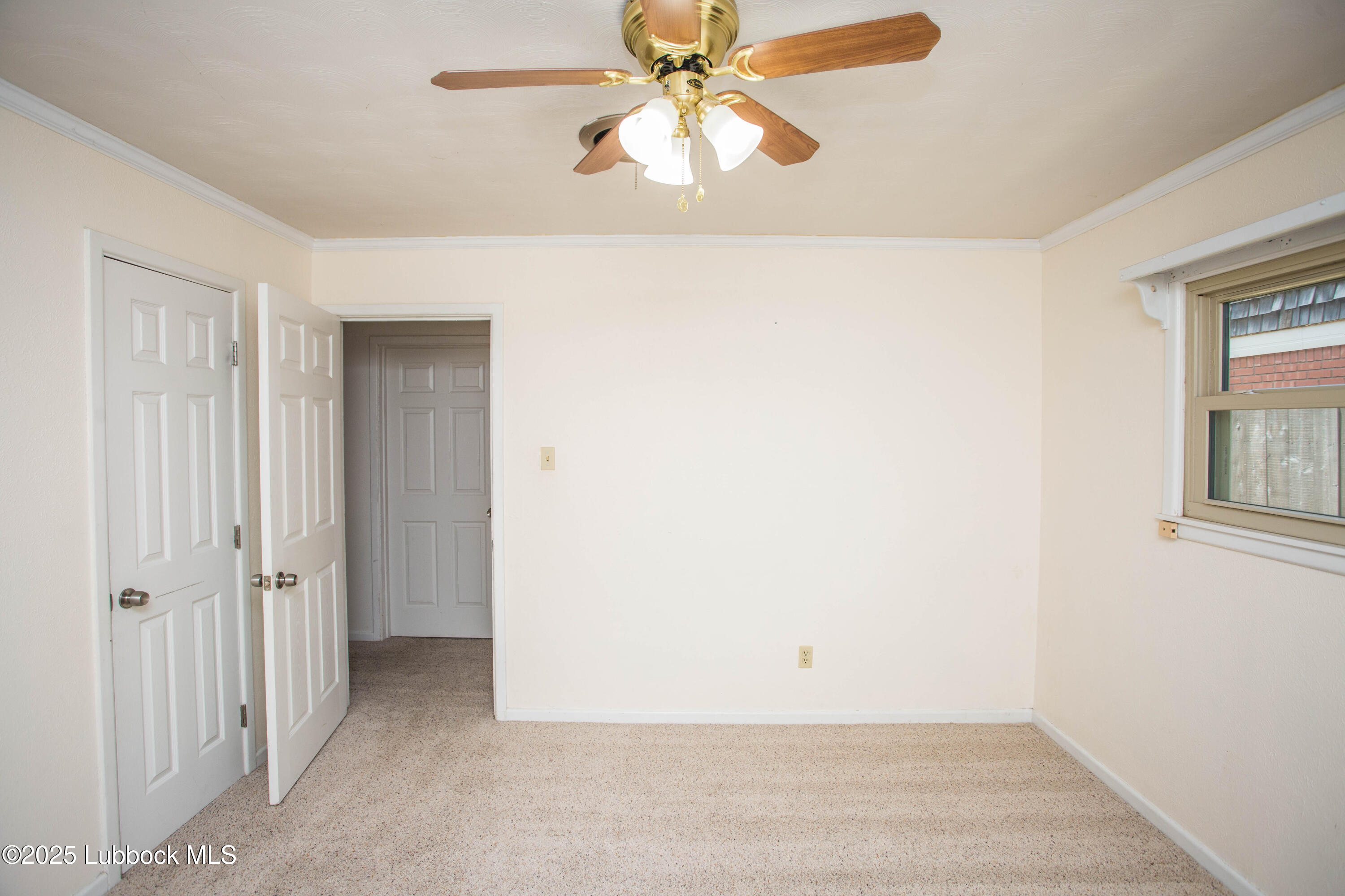 5424 31st Street Lubbock, TX 79407 - Photo 29 of 45 an empty room with windows and fan