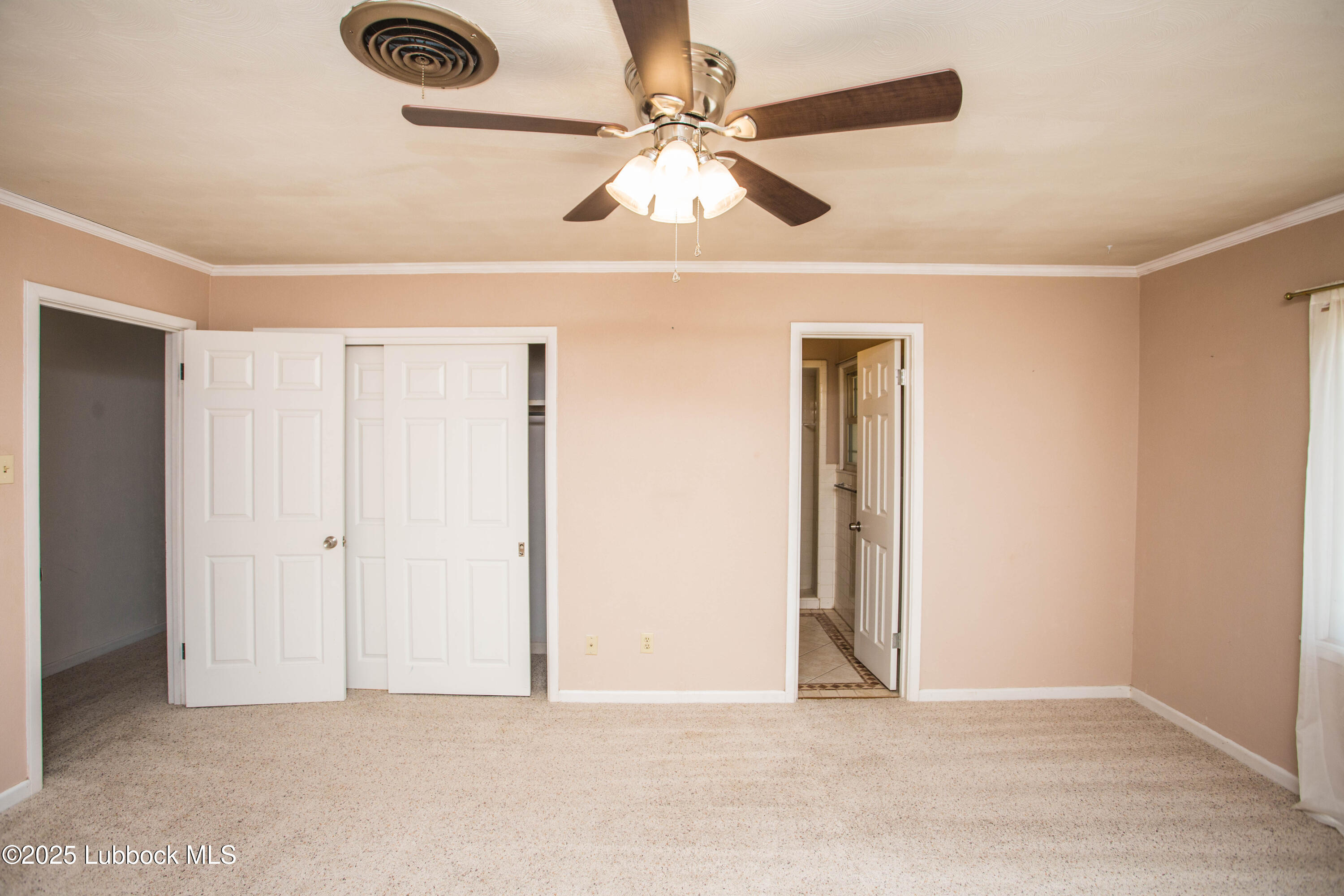 5424 31st Street Lubbock, TX 79407 - Photo 32 of 45 an empty room with windows and fan