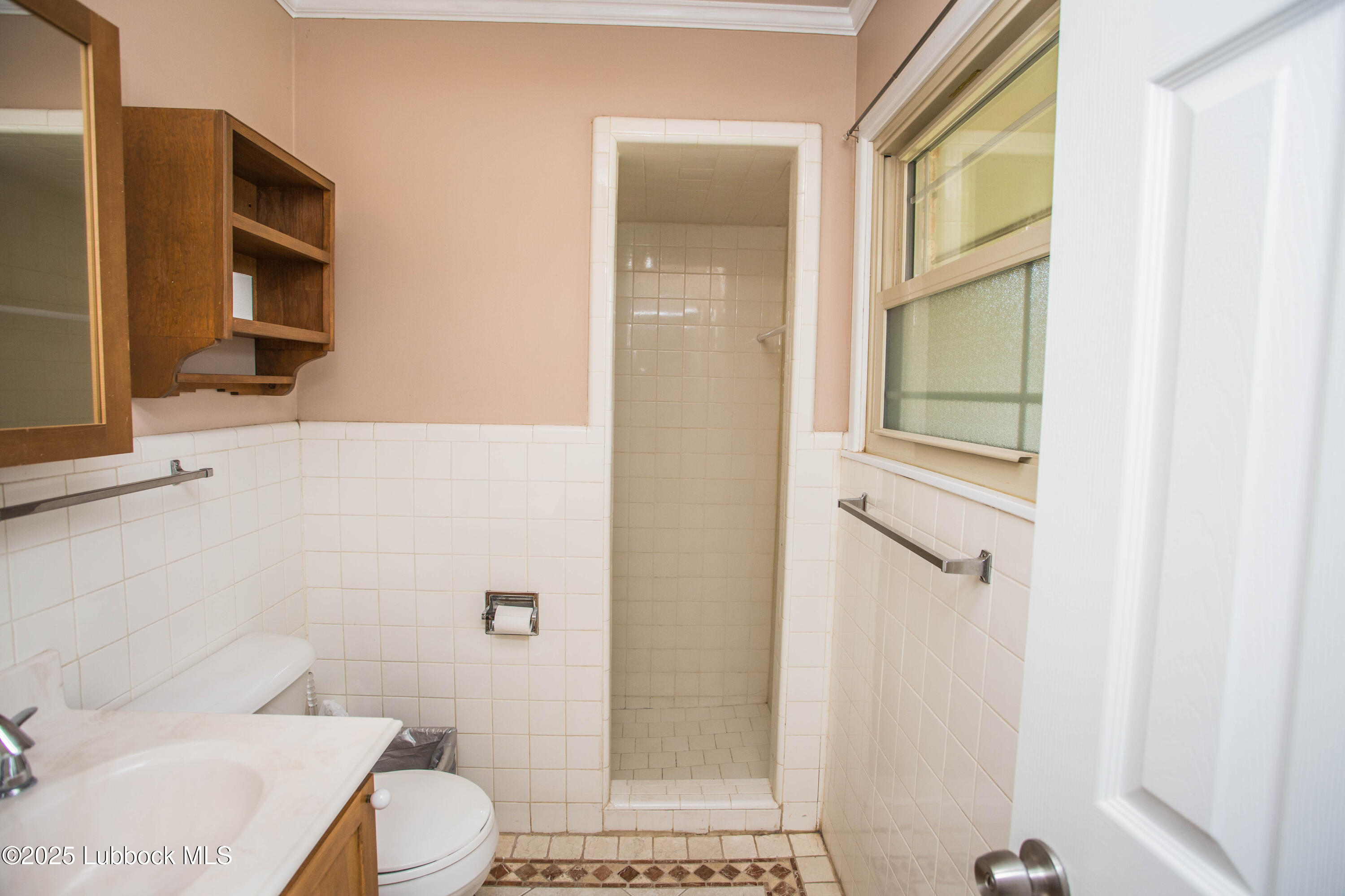 5424 31st Street Lubbock, TX 79407 - Photo 33 of 45 a bathroom with a toilet a sink and shower