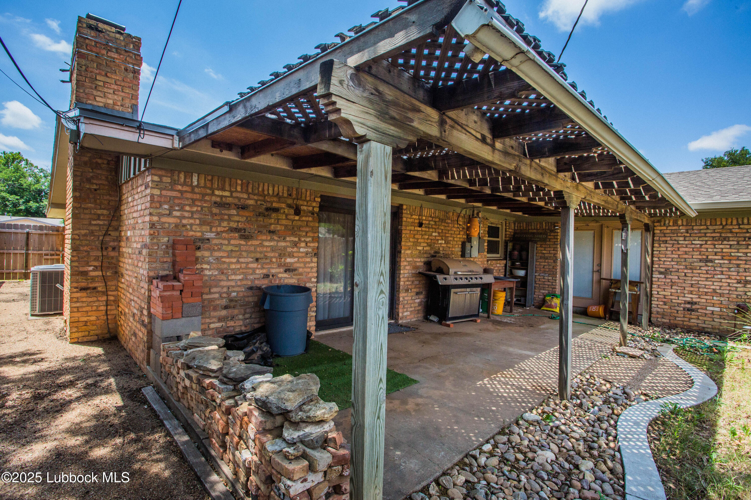 5424 31st Street Lubbock, TX 79407 - Photo 45 of 45 a view of a patio with table and chairs and potted plants