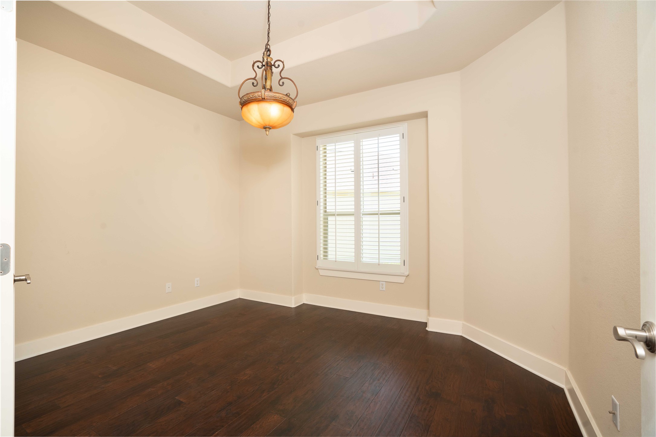 210 Rivulet Lane Austin, TX 78738 - Photo 21 of 28 Rich hardwood floors complement the elegant light fixture in this inviting room.