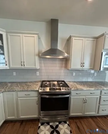 a kitchen with a stove and a sink
