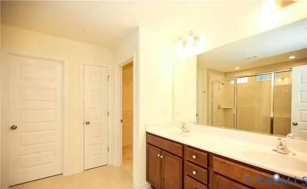 a bathroom with a double vanity sink and a mirror