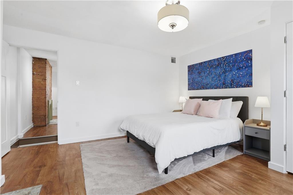187 42nd Street Pittsburgh, PA 15201 - Photo 11 of 26 a bedroom with a bed and a night stand
