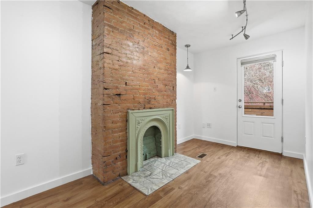 187 42nd Street Pittsburgh, PA 15201 - Photo 13 of 26 a view of a livingroom with wooden floor a ceiling fan and windows