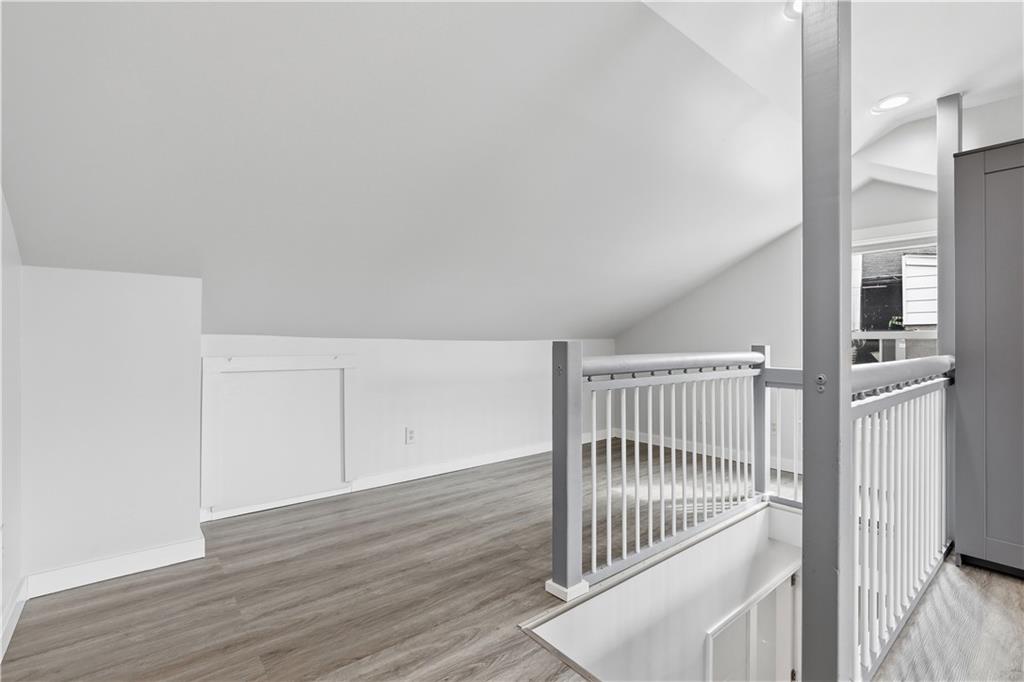 187 42nd Street Pittsburgh, PA 15201 - Photo 19 of 26 a view of staircase with white walls and wooden floor