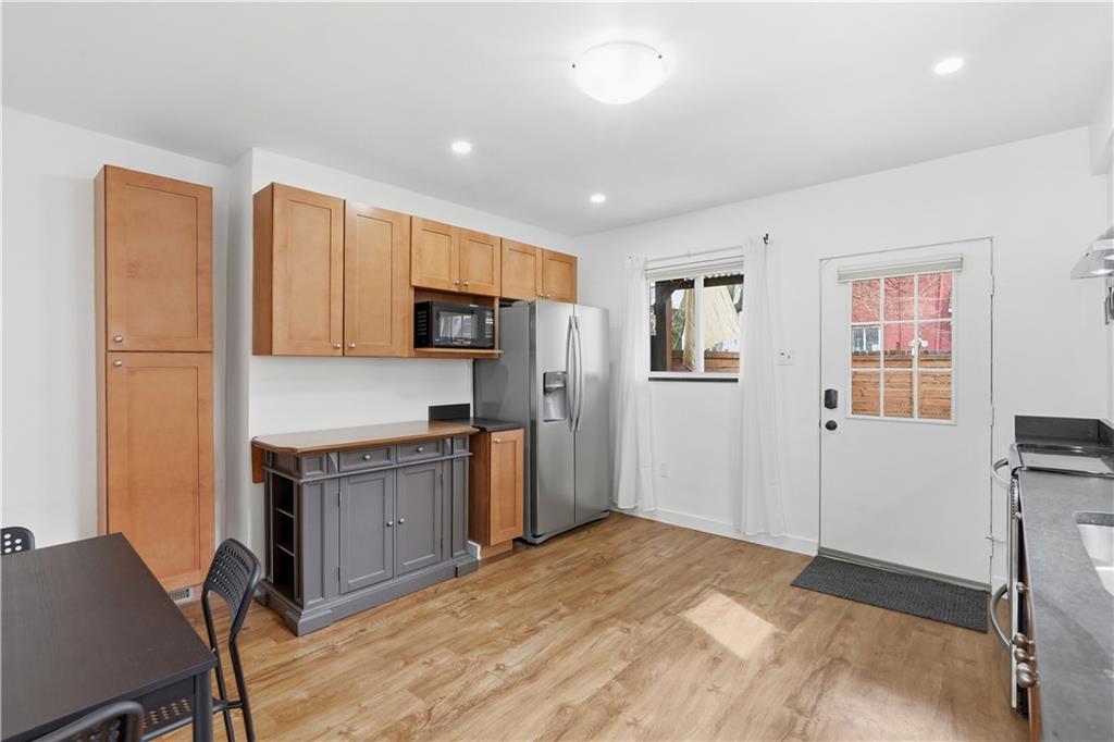 187 42nd Street Pittsburgh, PA 15201 - Photo 6 of 26 a kitchen with granite countertop a refrigerator stove top oven and sink