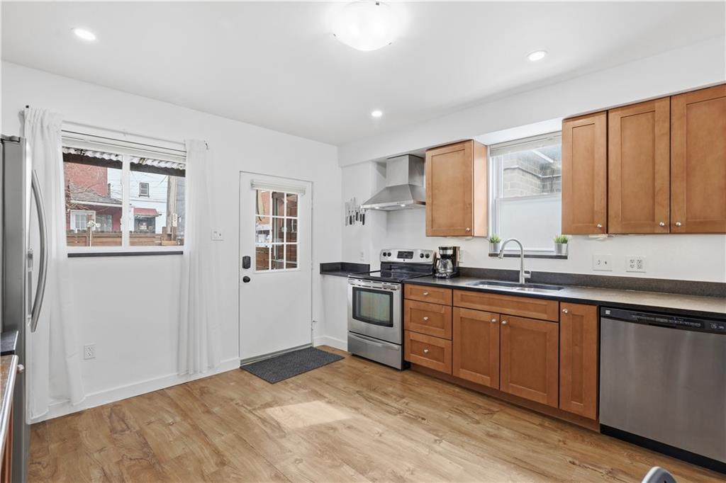 187 42nd Street Pittsburgh, PA 15201 - Photo 7 of 26 a kitchen with stainless steel appliances granite countertop a stove sink and cabinets