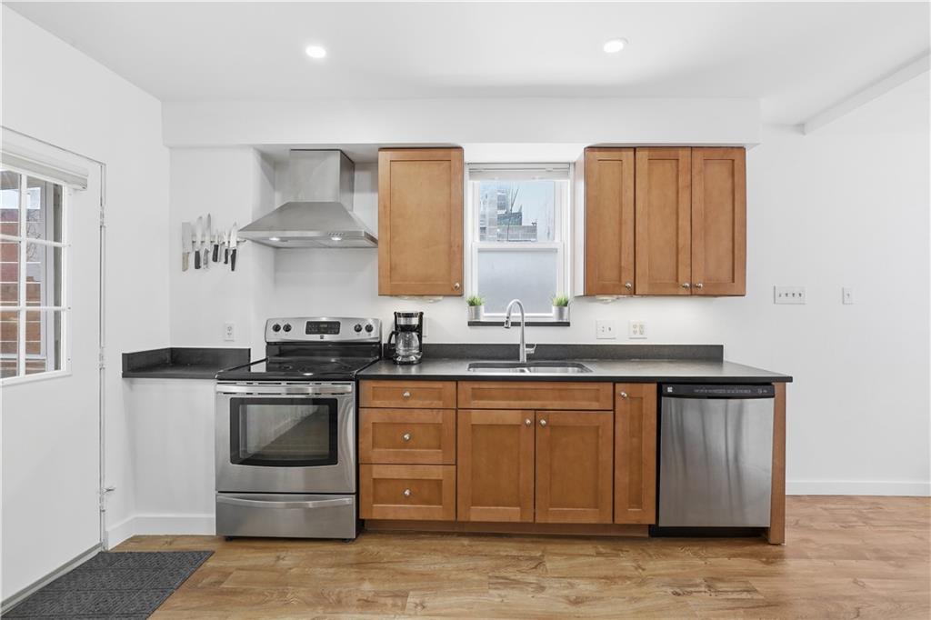187 42nd Street Pittsburgh, PA 15201 - Photo 9 of 26 a kitchen with stainless steel appliances granite countertop a stove and a sink