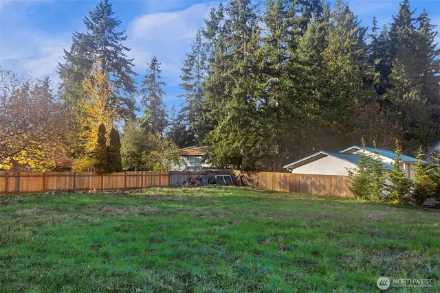 a view of a house with a backyard