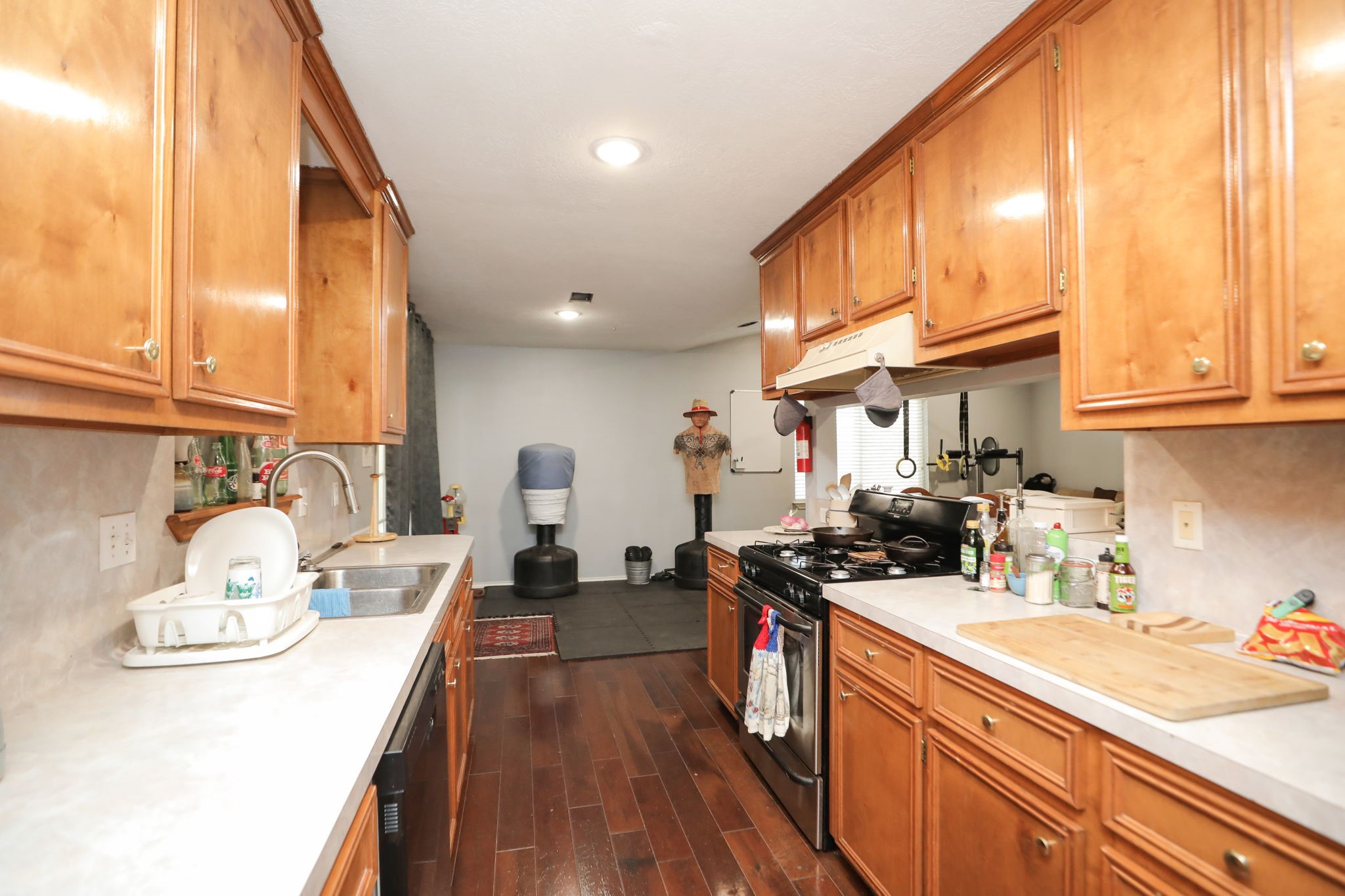 9810 Sugar Tree Court Houston, TX 77070 - Photo 11 of 30 a kitchen with a sink a stove and cabinets