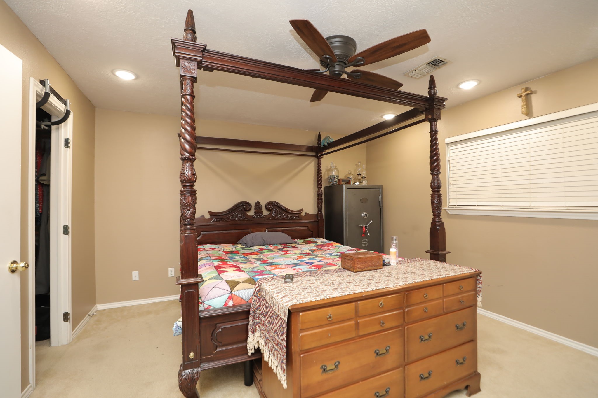 9810 Sugar Tree Court Houston, TX 77070 - Photo 14 of 30 a bedroom with a bed a chandelier and a window